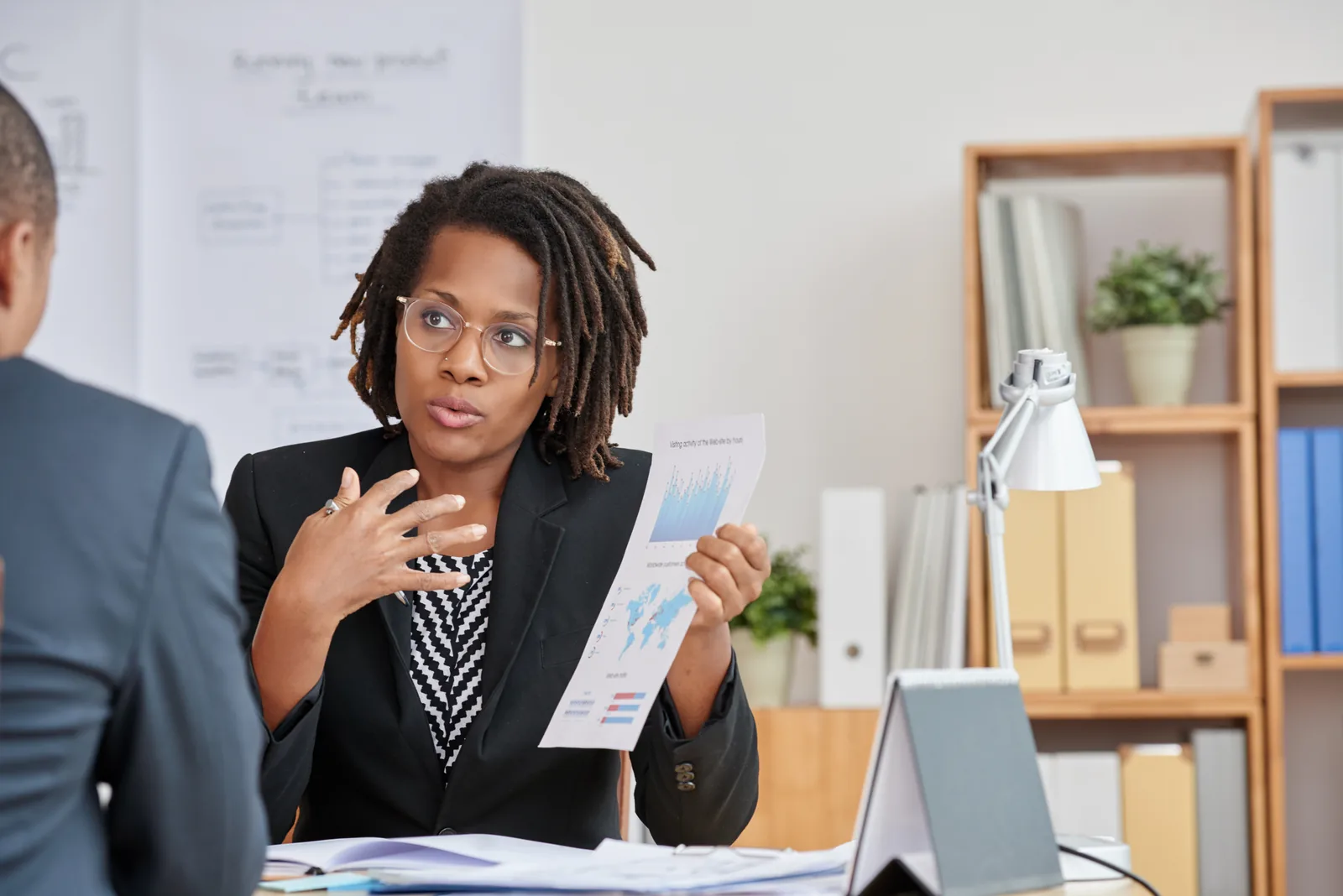 A finance adviser presenting business information during a professional consultation.